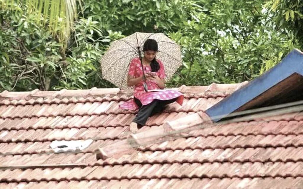 Kerala-woman-studying-on-roof