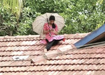 Kerala-woman-studying-on-roof