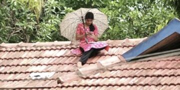Kerala-woman-studying-on-roof