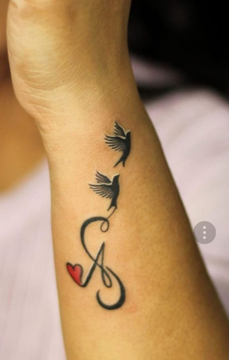 A letter tattoo with flying birds