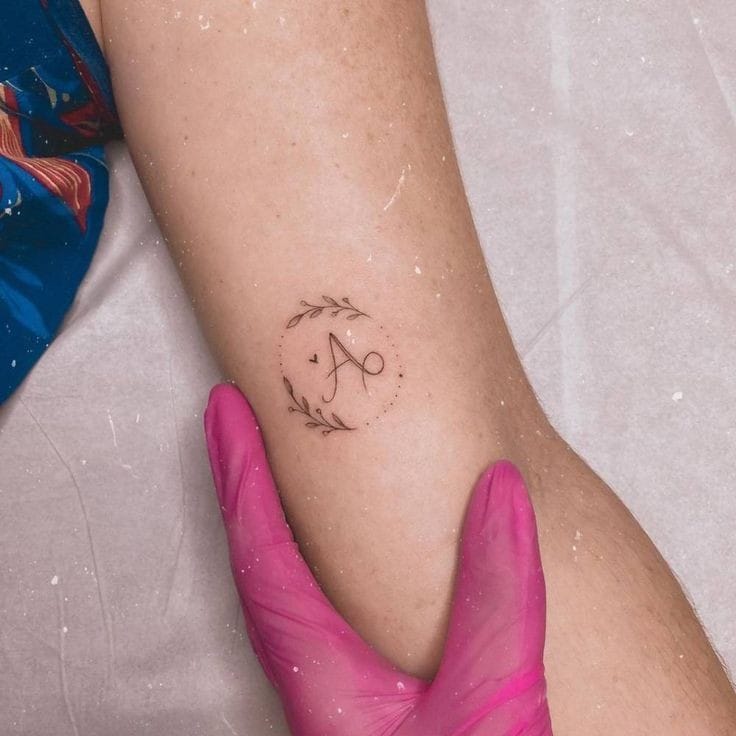 A letter with leaves tattoo