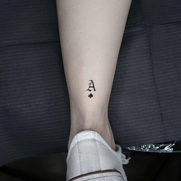 A letter with spade card tattoo