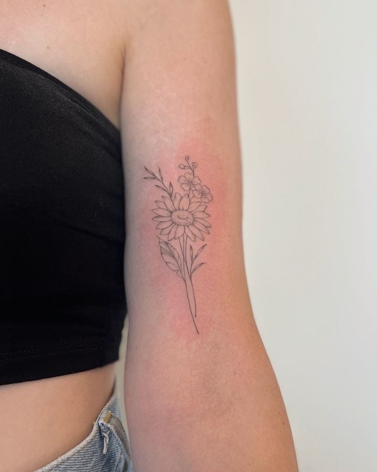 Tatuagem de flor de margarida e miosótis