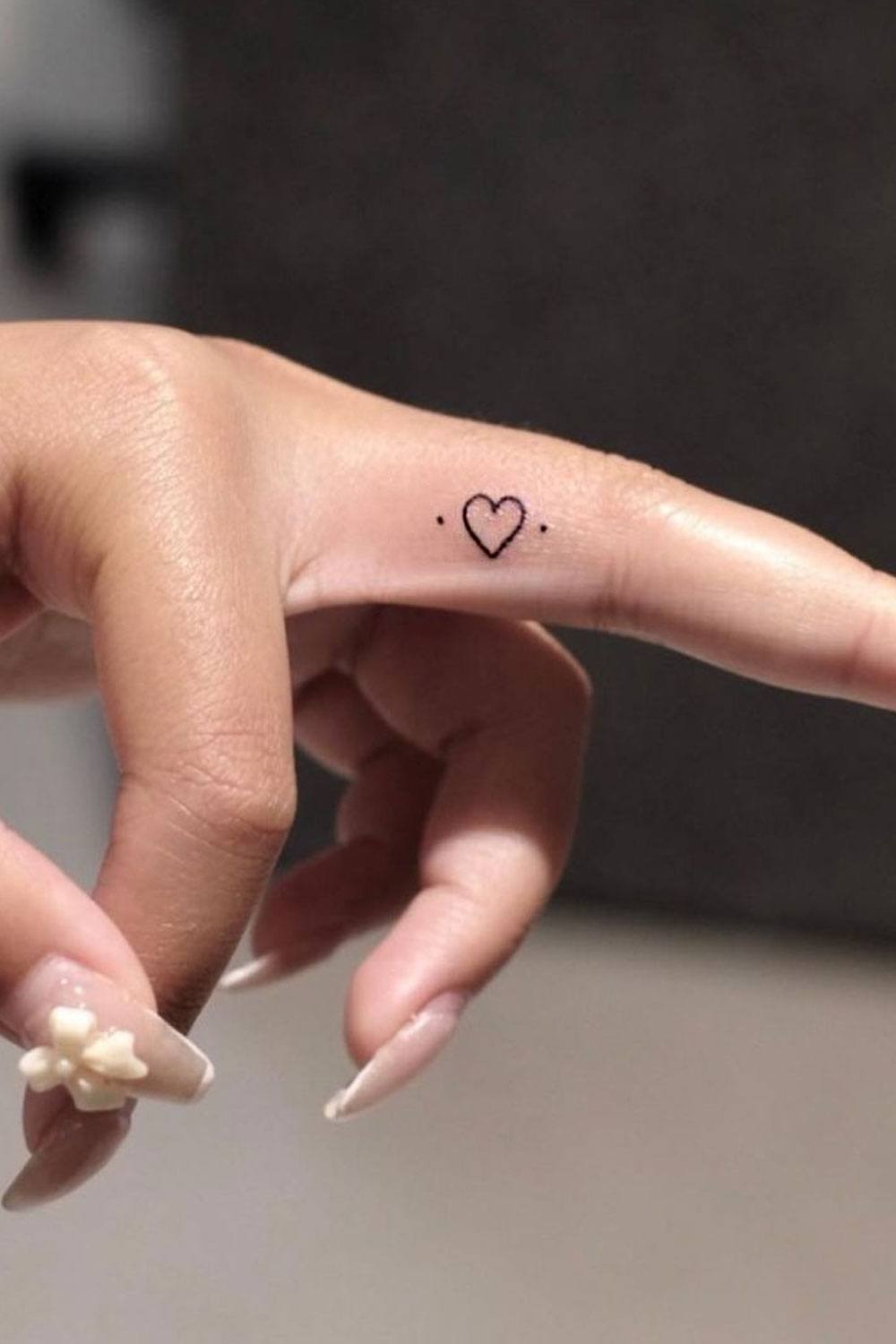 Tiny Minimalist Heart Tattoo On Finger