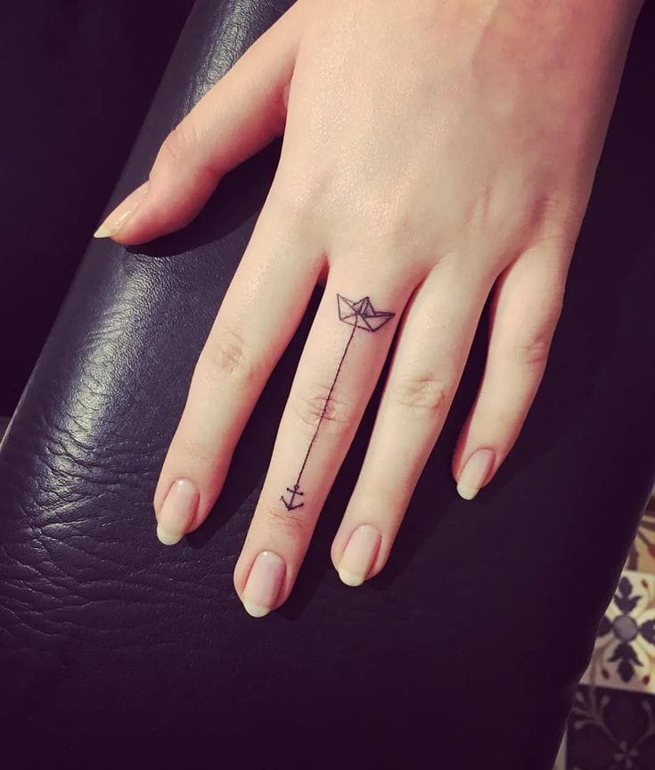Paper boat small finger tattoo