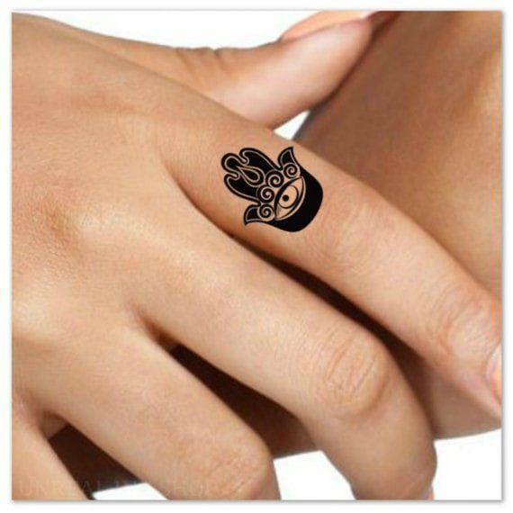 hamsa finger tattoo