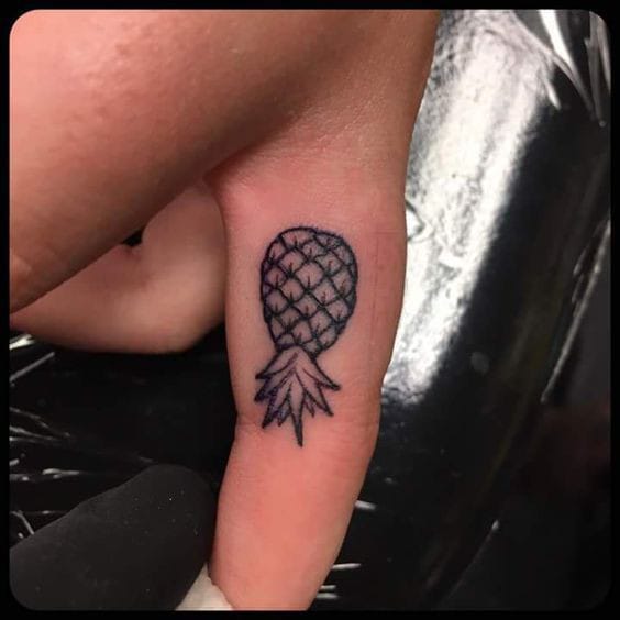 miniature pineapple finger tattoo
