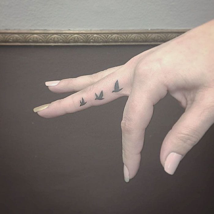origami bird finger tattoo