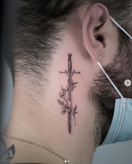 Behind-the-ear sword tattoo